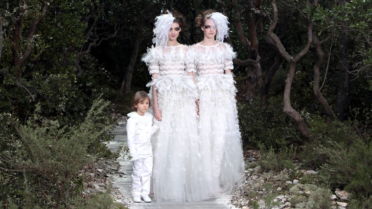 Models present creations for Chanel with Hudson Kroenig, German designer Karl Lagerfeld's godson, during the Haute Couture Spring-Summer 2013 collecti...