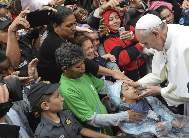 Pope Francis blesses a child during his visit to the Varginha slum in Rio de Janeiro, Brazil, on July 25, 2013. Francis visited one of Rio de Janeiro's shantytowns, or favelas, a place that saw such rough violence in the past that it's known by locals as the Gaza Strip.