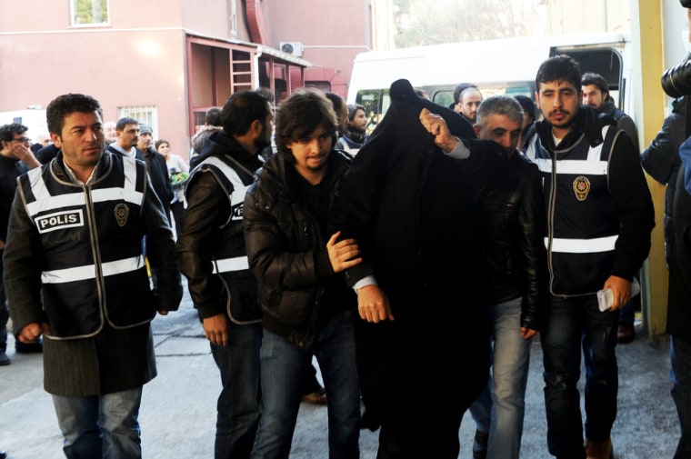 People arrested as part of a probe into alleged corruption arrive at the hospital for a medical check-up at the start of their custody in Istanbul on Thursday.