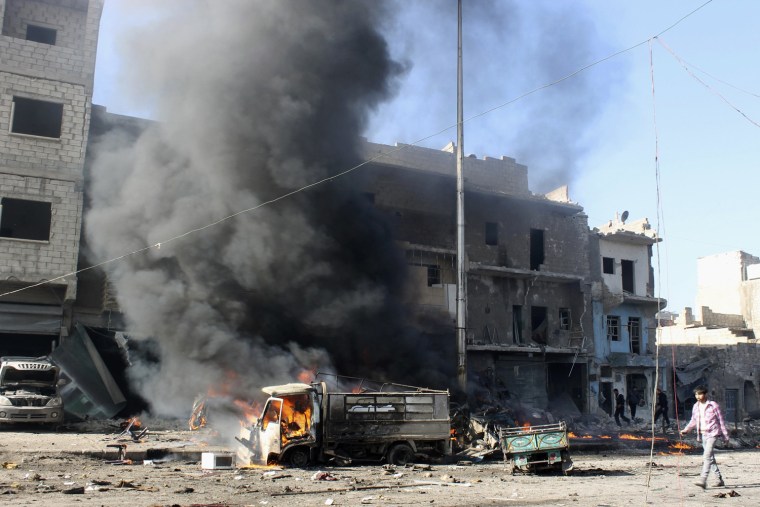 Smoke rises from a vehicle after what activists said was heavy shelling by forces loyal to Syrian President Bashar Al-Assad, in Masaken Hanano in Aleppo, December 22, 2013.