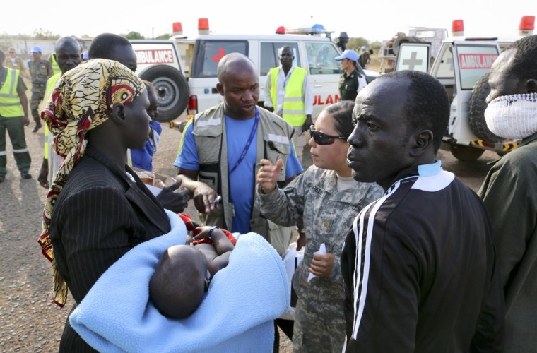 Wounded civilians from Bor, the capital of Jonglei state and said to be the scene of fierce clashes between government troops and rebels, are assisted after being transported by U.N. helicopter to Juba, South Sudan, on Dec. 22.