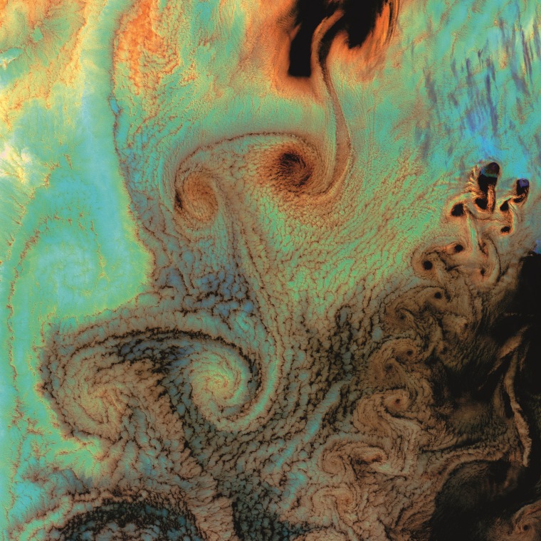 Clouds swirl over the Aleutian Islands in a pattern known as a Karman vortex street, as seen in a Landsat 7 satellite image from July 4, 2002.