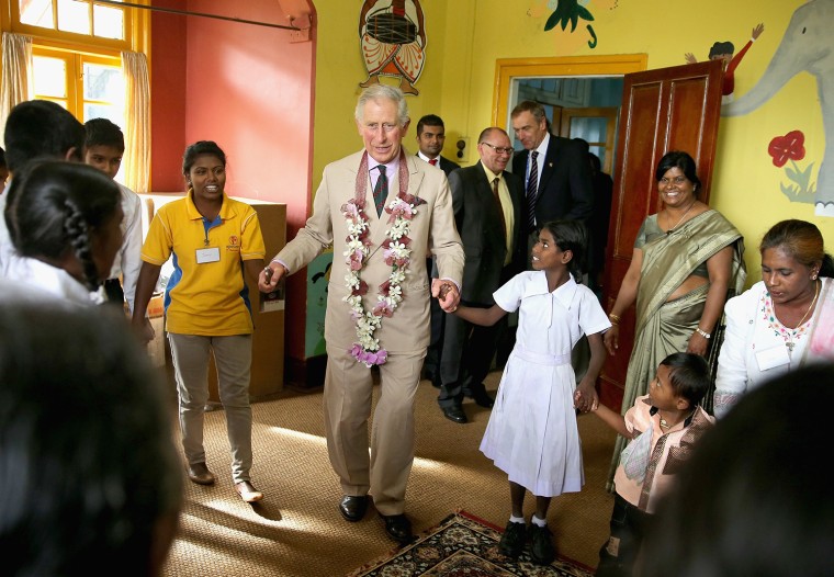 NUWARA ELIYA, SRI LANKA - NOVEMBER 16:  Prince Charles, Prince of Wales takes part in the 'Hokey Cokey' with disabled children as he visits MEDCAFEP D...