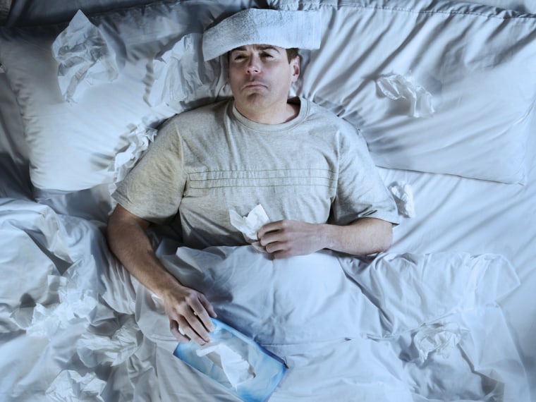 Man lying in bed ill