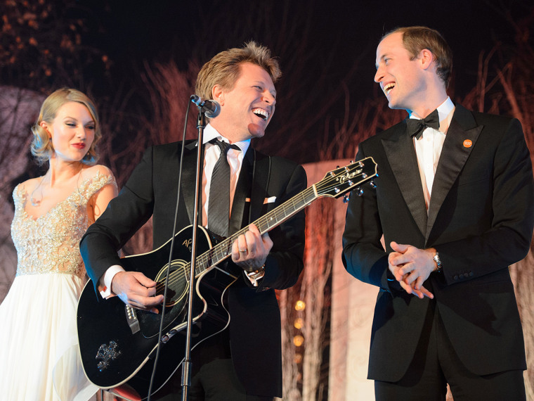 Britain's Prince William, the Duke of Cambridge, right, sings with US singers Taylor Swift, left, and Jon Bon Jovi at the Centrepoint Gala Dinner at K...