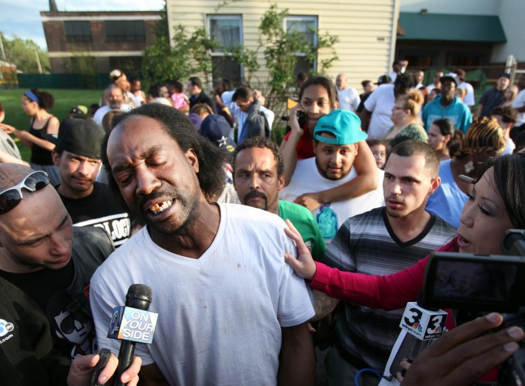 Charles Ramsey talks to members of the media as people congratulate him on helping some women escape from captivity in a Cleveland home on May 6.