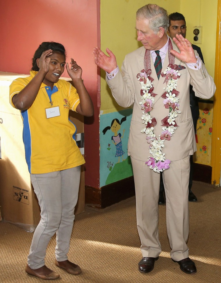 NUWARA ELIYA, SRI LANKA - NOVEMBER 16:  Prince Charles, Prince of Wales takes part in the 'Hokey Cokey' with disabled children as he visits MEDCAFEP D...