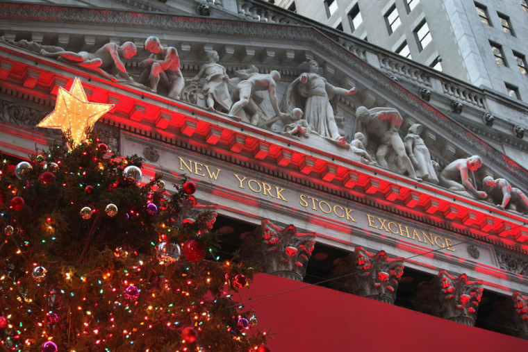 Lights for the holidays illuminate the New York Stock Exchange. The Dow Jones Industrial Average closed at a record high Tuesday in holiday-shortened ...