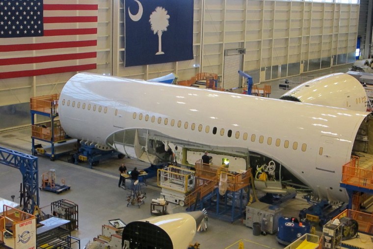 Workers assemble Boeing 787 Dreamliners in the company's massive assembly plant in North Charleston, S.C., on Thursday, Dec. 19, 2013. Orders for long-lasting manufactured goods such as aircraft jumped in November.