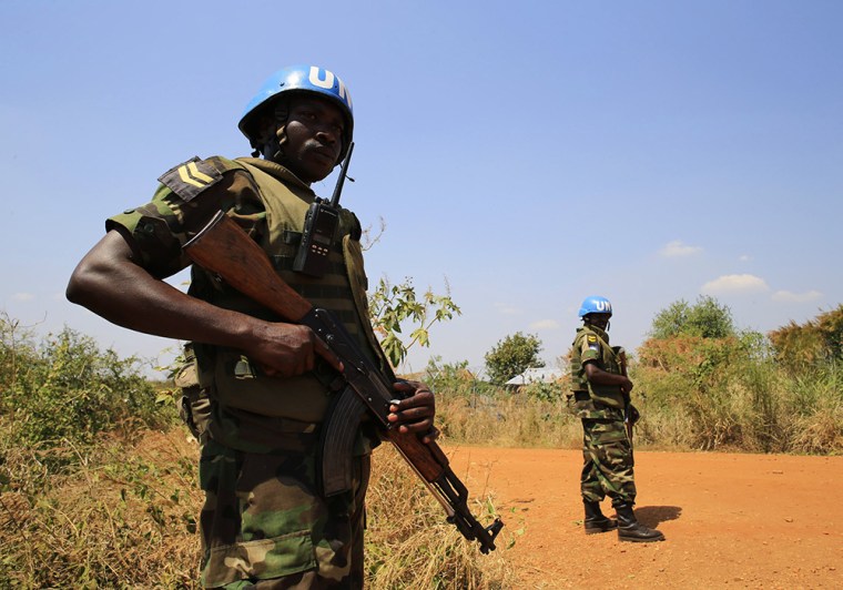 United Nations Mission in Sudan personnel guard South Sudanese people displaced by recent fighting in Jabel, on the outskirts of capital Juba on Monday.
