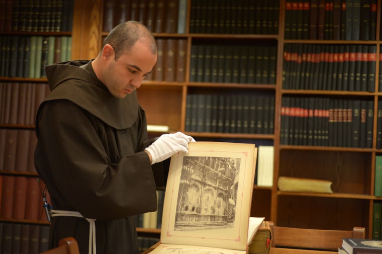 Father Alberto Joan of the Custodia Terra Santa looks at centuries old images from the Holy Land in the archive room of his order in the Jerusalem.