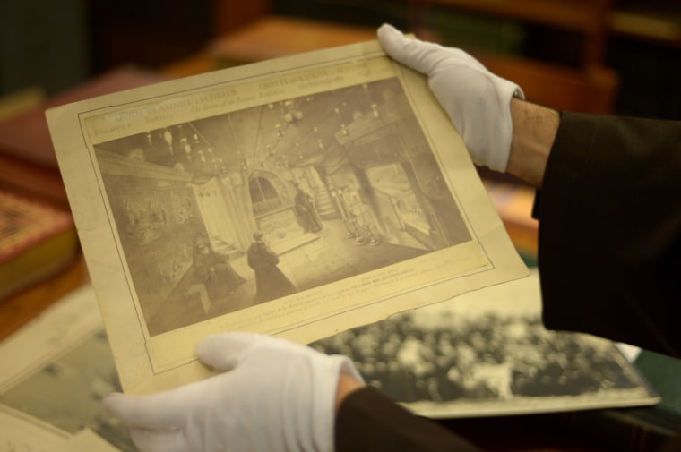 Father Alberto Joan of the Custodia Terra Santa hold an image of the Church of the Nativity in the archive room.