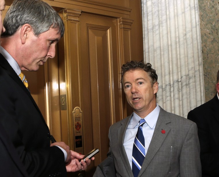 Senator Rand Paul (R-KY) (R) talks to reporters outside of the Senate chamber after voting on the U.S. budget bill in Washington December 18, 2013.