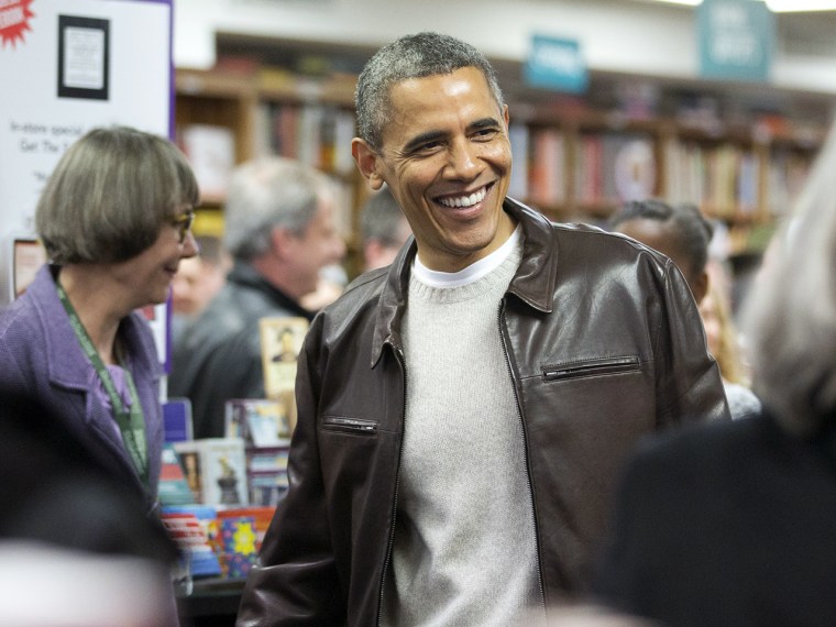 President Barack Obama greets shoppers as he shops at the local bookstore Politics and Prose in northwest Washington, Saturday, Nov. 30, 2013.  (AP Ph...