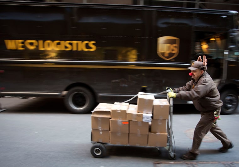 UPS delivery man Vinny Ambrosino prepares to deliver packages on Christmas Eve while wearing a Rudolf nose and antlers in New York. Some retailers missed their promised Christmas deliveries in part because of UPS.