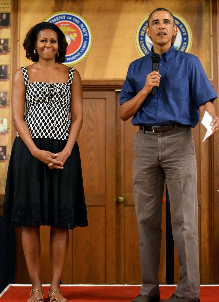 President Obama has updated his pleated dad pants look of a year ago with flat front pants and a short-sleeved button down shirt that he wore to a gathering with military members and their family in Hawaii during his annual Christmas vacation with his family.