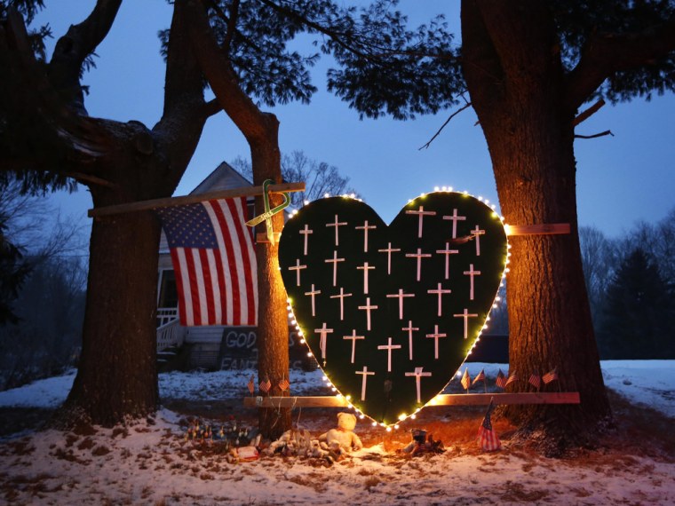 A makeshift memorial with crosses for the victims of the Sandy Hook massacre stands outside a home in Newtown, Conn., on Dec. 14 — the year anniversary of the shootings.