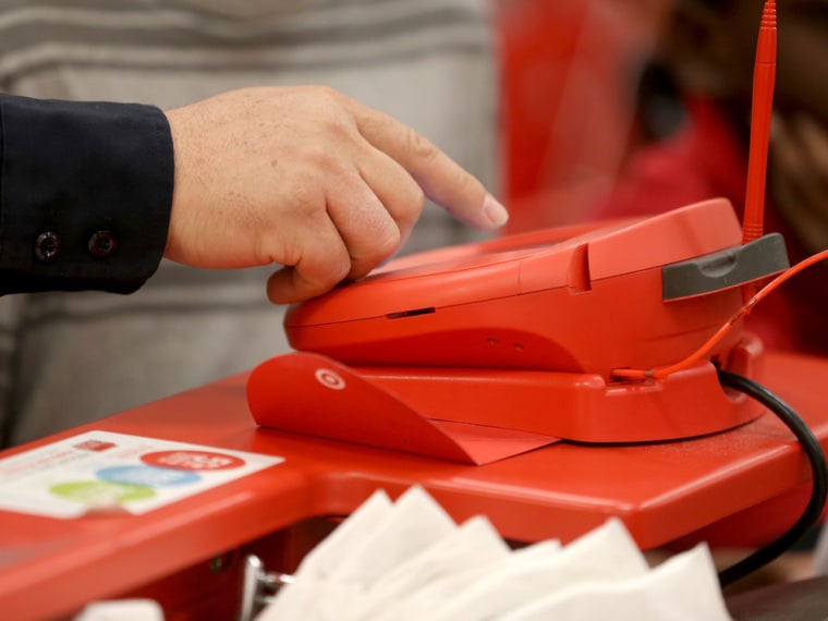 IMAGE: Customer swipes credit card at a Target store