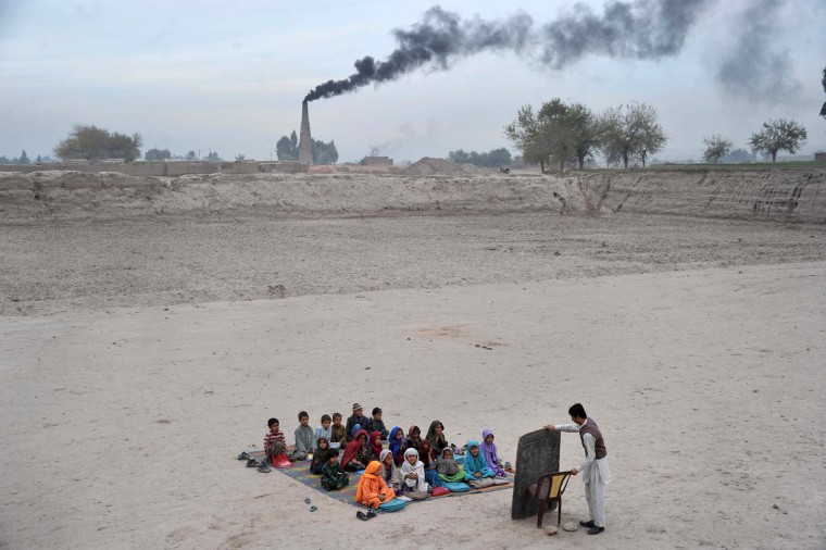 Achoolchildren take lessons in an open classroom at a refugee camp in Nangarhar province, Afghanistan, on Dec. 1.