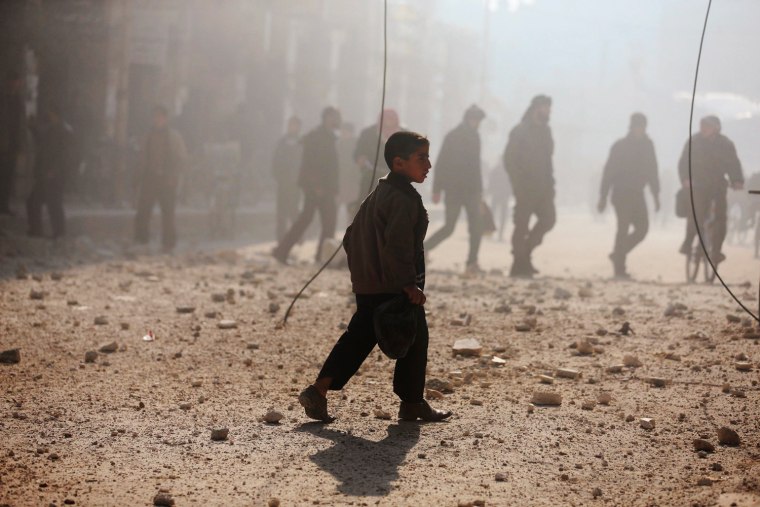 A boy walks near a damaged site after what activists said was heavy shelling by forces loyal to Syrian President Bashar Assad in Duma, Damascus, on Dec. 22.