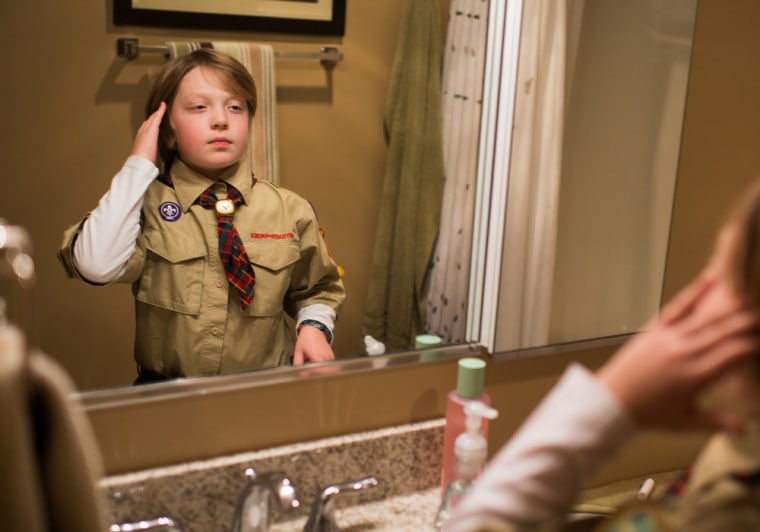 Jack Wallace combs his hair before an outing with his Cub Scout pack on Dec. 18, 2013, in LaSalle, Ill. His mother allowed him to join the Scouts only after the organization voted to admit openly gay youth.