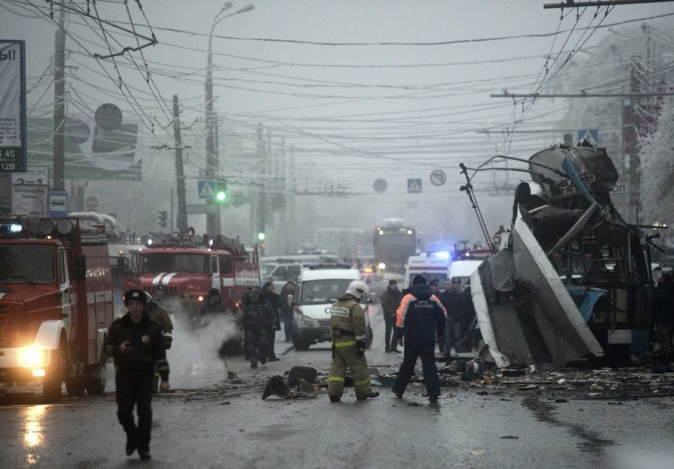 Members of the emergency services work at the site of a bomb blast on a trolleybus in Volgograd December 30, 2013. At least 10 people were killed when...