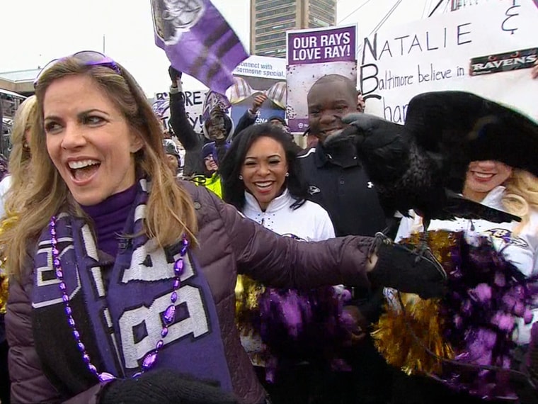 A live raven perches on Natalie's hand during the Super Bowl pep rally in Baltimore.
