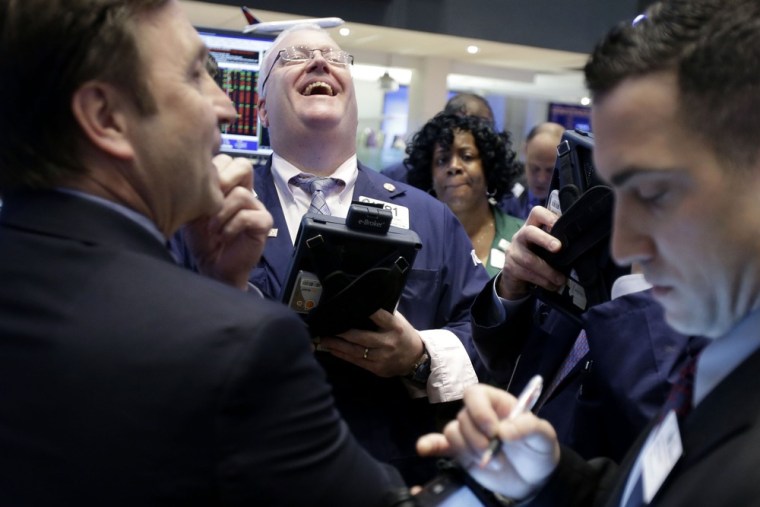 Things are looking up. A trader laughs while working on the floor of the New York Stock Exchange in New York, Thursday, Jan. 31, 2013, the day before ...
