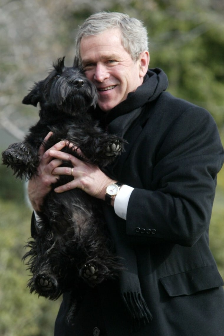 U.S. President George W. Bush holds up  Barney as he walks the South Lawn of the White House on Feb. 3, 2002 in Washington, DC.