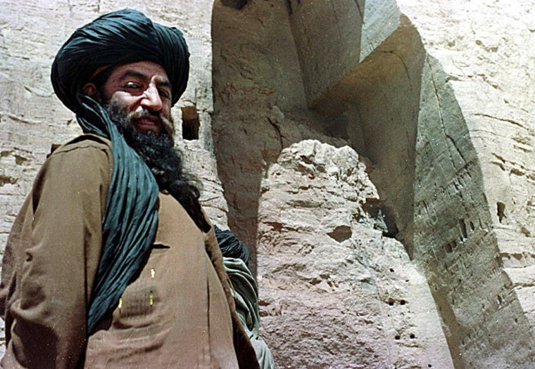 A member of the Taliban stands near the remnants of a Buddha statue in Bamiyan, Afghanistan, in March 2001. The militia blew up two ancient Buddhas after a decree from their supreme commander to destroy all of the country's statues.