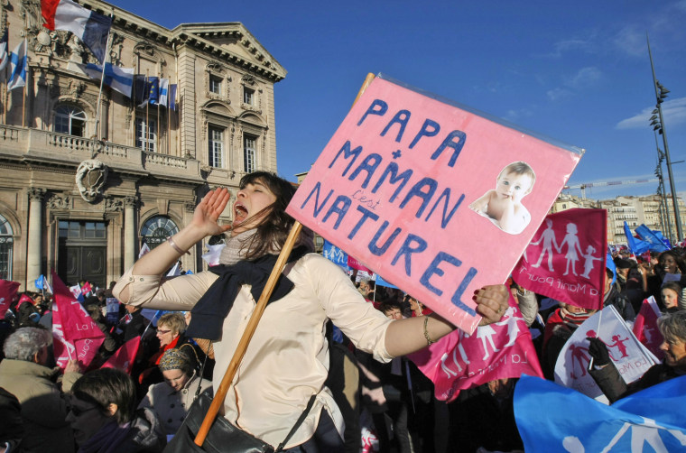 Opponents to government plans to legalize same-sex marriage, adoption and medically-assisted procreation for same-sex couples, shout slogans during a demonstration, in Marseille, southern France, on Feb. 2. Placard reads