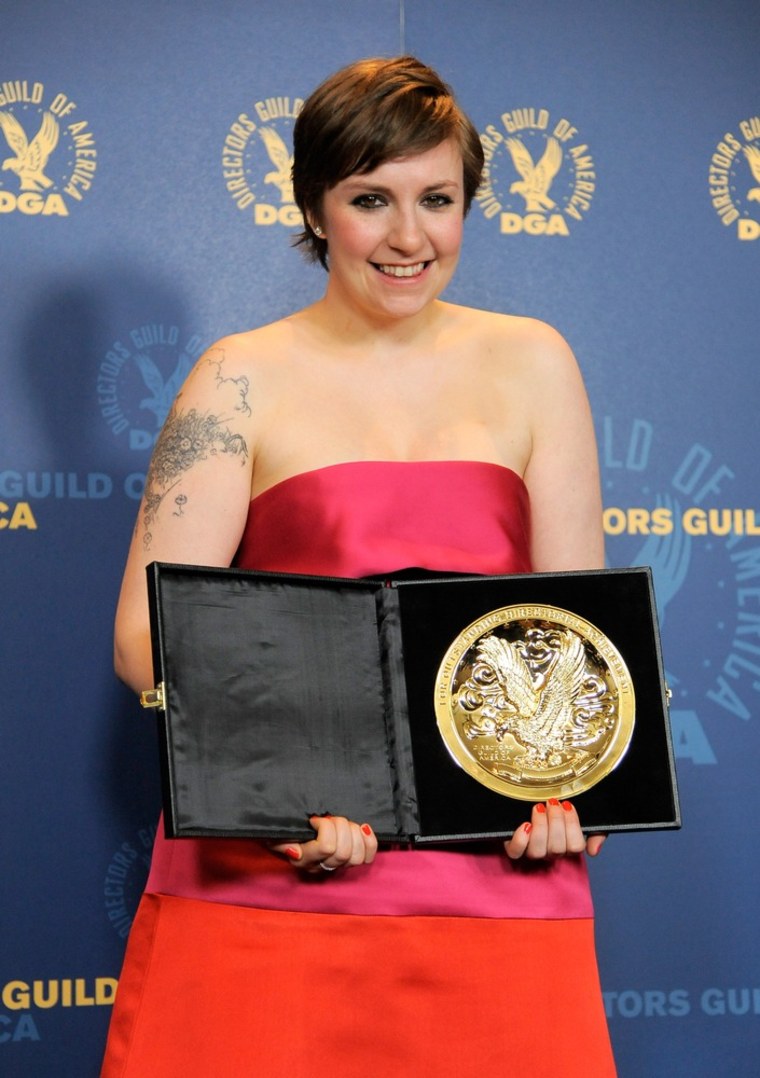 Lena Dunham poses backstage with the comedy series award for \"Girls\"' at the 65th Annual Directors Guild of America Awards.
