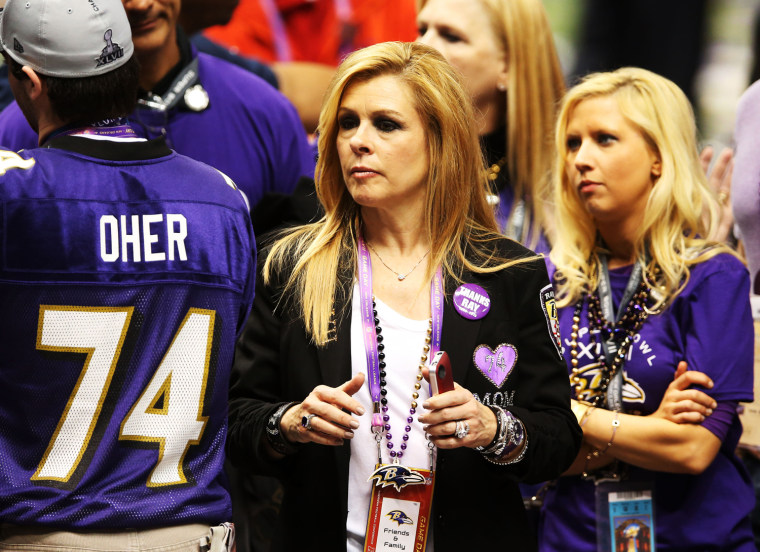 Leigh Anne Tuohy celebrates on the field after her adoptive son Michael Oher and the Ravens won the Super Bowl.