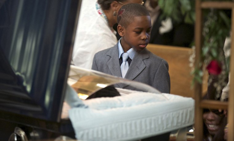 Ronnie Chambers Jr. looks at his mother Tahitah Myles (obscured) as she collapses during the funeral for his father Ronnie Chambers, 33, a victim of gun violence, in Chicago Feb.4. Shirley Chambers of Chicago had four children - three boys and a girl. Now they're all gone. Her son, Ronnie Chambers, was the last of the single mother's children - all victims of gun violence in Chicago over a period of 18 years.