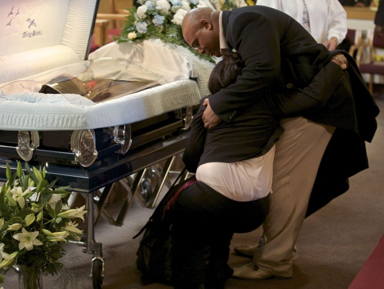 Shirley Chambers collapses during the funeral for her son Ronnie Chambers, 33, a victim of gun violence, in Chicago Feb. 4.