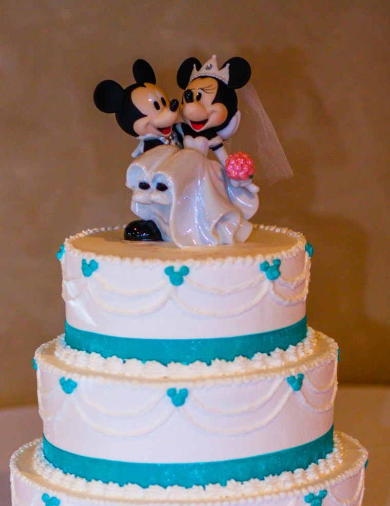 A Mickey and Minnie-topped wedding cake.