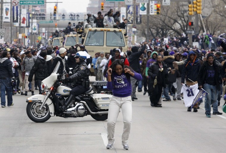 A Baltimore Ravens fan dances in the street on the team's parade route in Baltimore on Feb. 5.