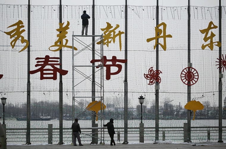 Chinese workers set up decorations for the upcoming Chinese New Year in Dandong, China, on Tuesday. Dandong is located across the Yalu river from the North Korean town of Sinuiju.
