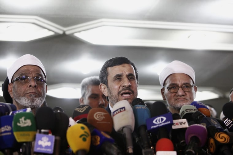 Ahmadinejad speaks to the media flanked by two Sheikhs of the Al Azhar mosque during a press conference in Cairo Tuesday.