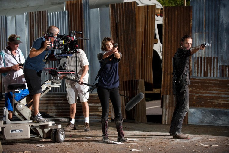 The crew of \"Walking Dead\" film a scene featuring Andrew Lincoln and Lauren Cohan.
