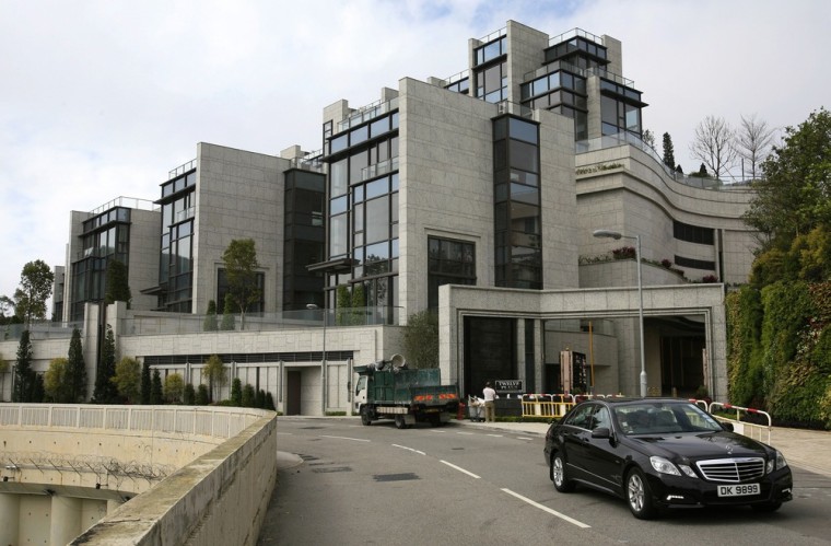A car passes luxury houses on Victoria Peak, Hong Kong's most exclusive neighborhood, on Feb. 7, 2013.
