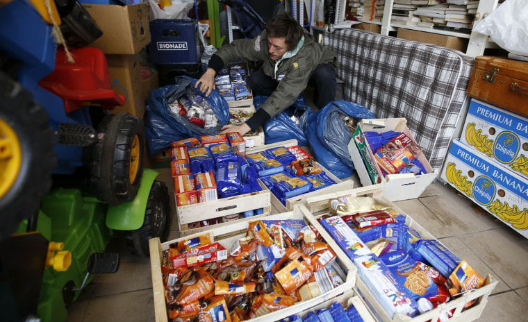 Raphael Fellmer, a supporter of the foodsharing movement shows Christmas biscuits collected from waste bins of supermarket at his home in Berlin, on Jan. 31.