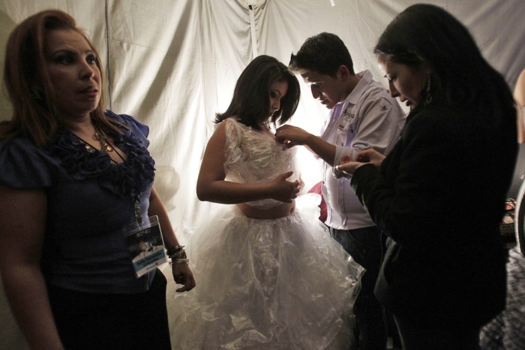 Cintia Caraguay of Ecuador prepares to model a creation before the start of Bionic Fashion Day. Caraguay lost her right leg to cancer.