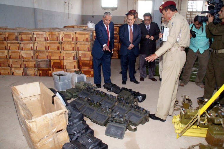 Yemeni Interior Minister Abdul-Qater Qahtan (left) and senior security officials inspect a variety of Iranian-made weapons seized at Aden port in Yemen.