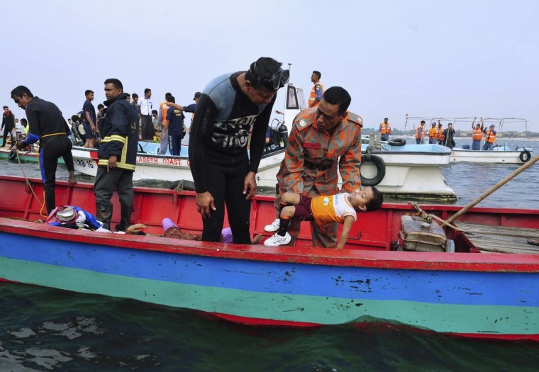 Rescue workers carry the body of a victim after a ferry sank in Munshiganj on Feb. 8, 2013.