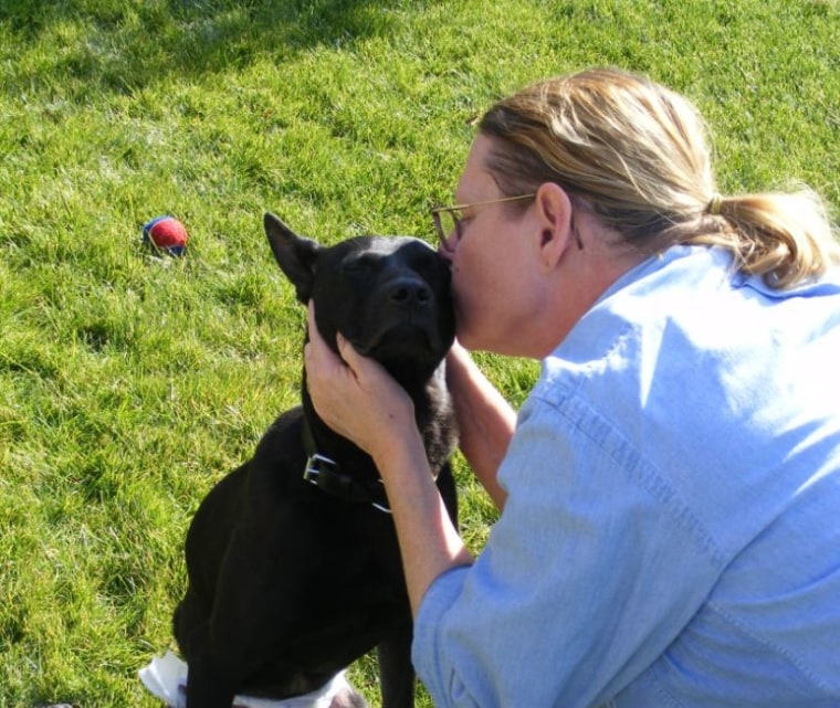 Batman gets a kiss from his new owner, Pam Goldwater.