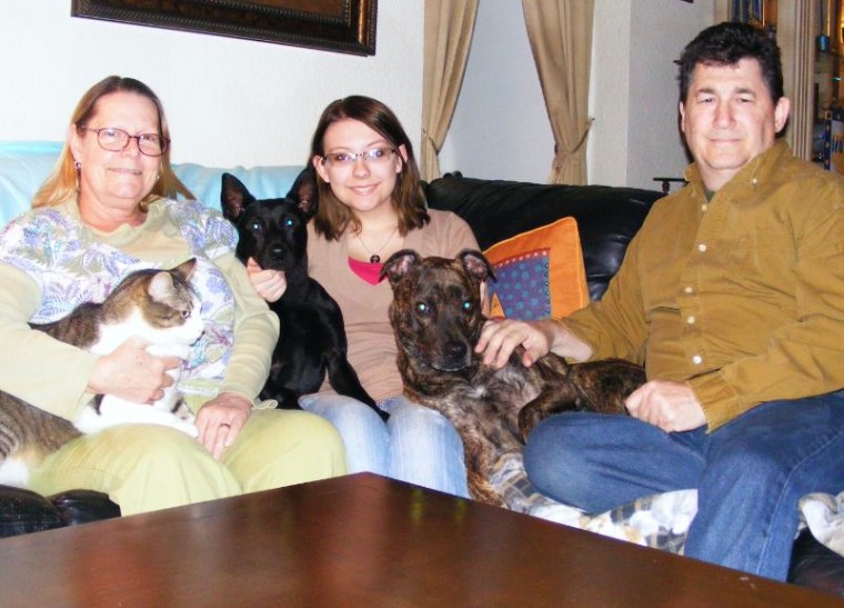 Batman, center, is pictured with his new family.