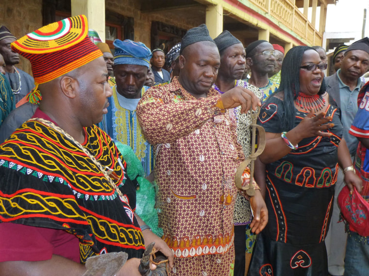 Cameroonians marvel over an 18th-century slave shackle that was brought to Africa for a