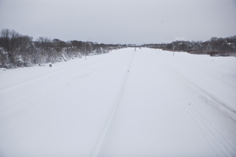 A snow-covered Long Island Expressway is seen from an overpass.