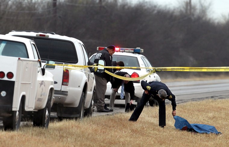 One of 91 deaths identified by guns across America on a long holiday weekend: Officers with the Bexar County, Texas, Sheriff's Office investigate the shooting death of Jesse Rosas, whose bullet-riddled body was found on the side of a road near San Antonio on Jan. 21. Police have not identified any suspects.